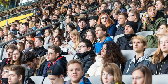 First semester students sit in the stands at the stadium during the welcoming of first-semester students.
