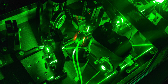 A detail shot of a laser in the lab in dark green colors.